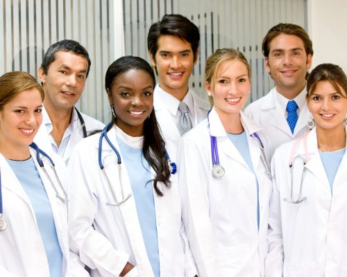 group of doctors in hospital smiling and looking friendly